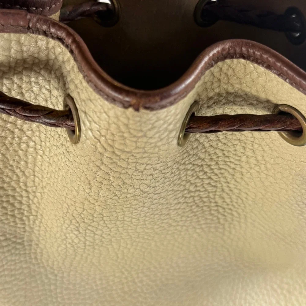 Dooney & Bourke All Weather Leather Bucket Drawstring Bag Tassel Beige Brown